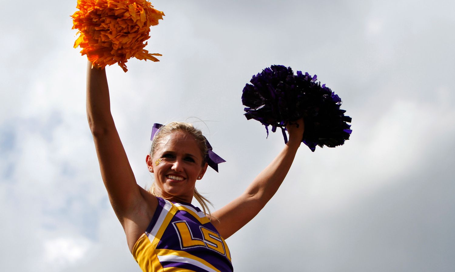 LSU Tigers cheerleader at a college football game in the SEC.